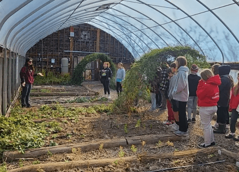 A group of people standing in an enclosed area.