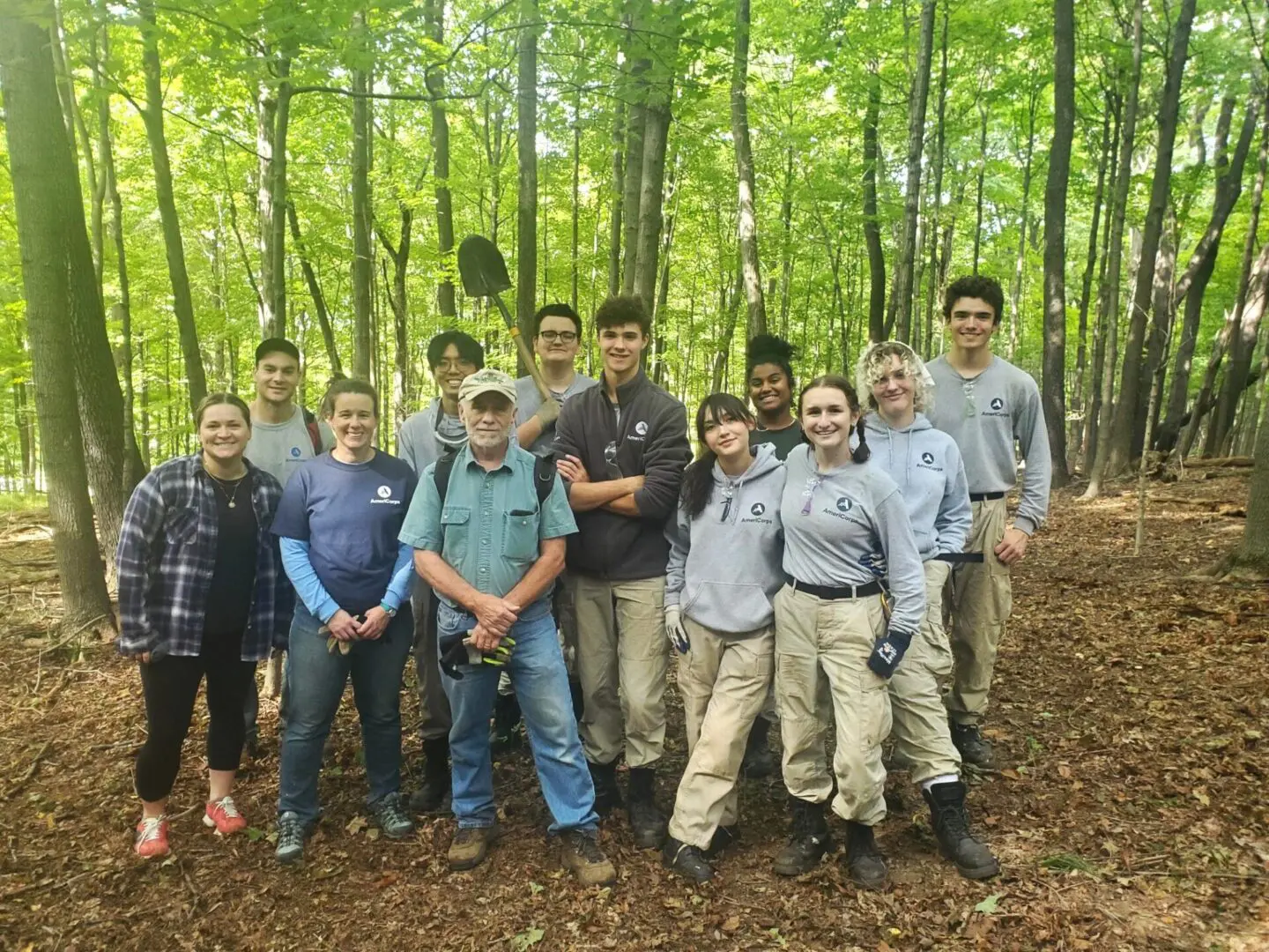 A group of people standing in the woods.