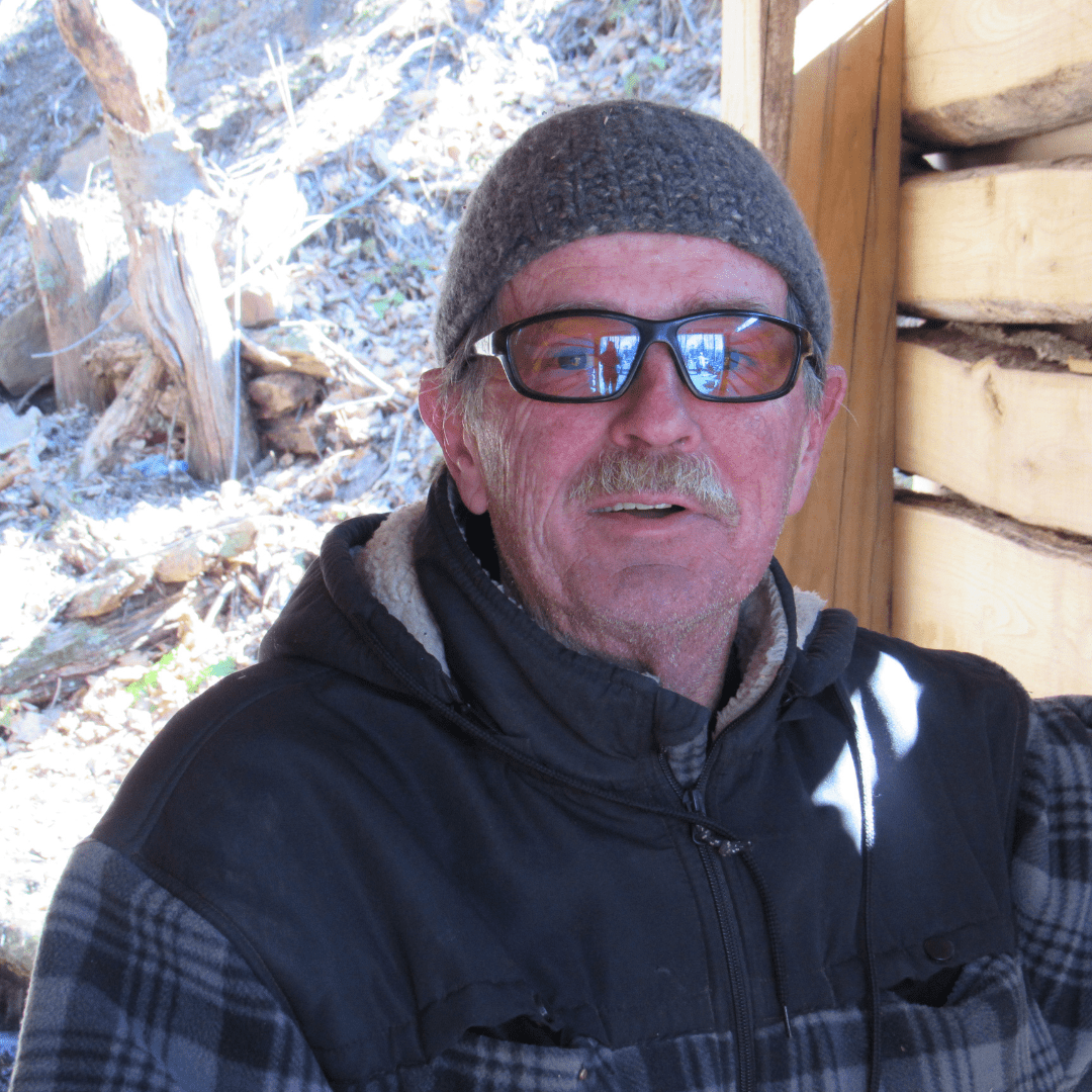 Man wearing sunglasses and a hat.