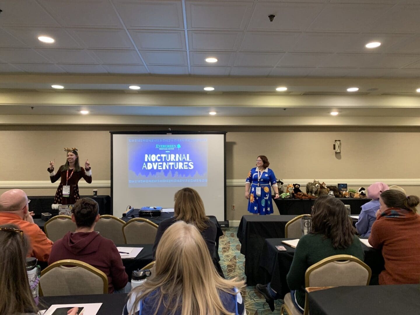 Two women presenting at a conference.